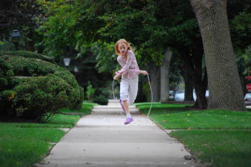 Girl jumping rope: Vision Therapy can improve a child's gross motor skills, like jumping or skipping